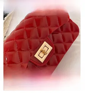 Close-up of glossy red quilted jelly bag featuring a golden metal twist lock closure