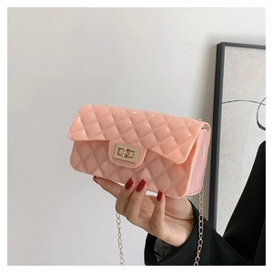 Detailed close-up of pink jelly crossbody bag featuring quilted texture and golden twist lock