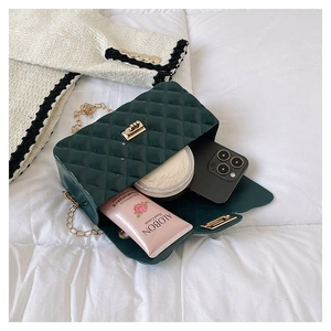 Detail of dark green quilted jelly bag interior showing storage space for cosmetics