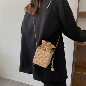 Beige mini crossbody box bag with geometric 3D embossed pattern and gold chain strap