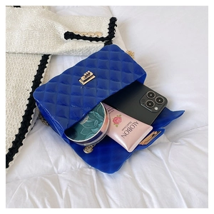 Detail of blue jelly bag interior showing storage for phone, cream and makeup