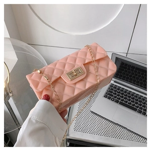 Detailed close-up of pink quilted jelly bag with gold chain strap and metal swivel lock