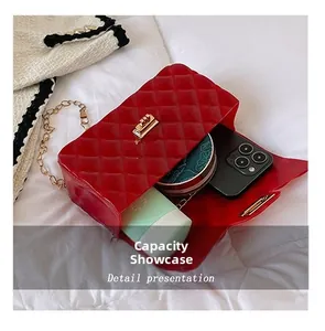 Detail presentation showing the interior capacity of the red quilted crossbody bag