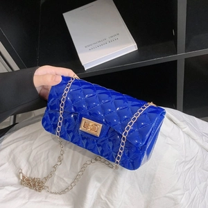 Bright blue quilted jelly crossbody bag with gold chain strap and turn-lock closure