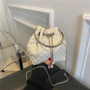 Cream quilted bucket bag with pearl drawstring and metal handle for women