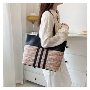 Large capacity tote bag with black leather and colorful woven ethnic patchwork design