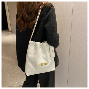 Stylish white quilted tote bag with gold chain decoration and mini card pouch