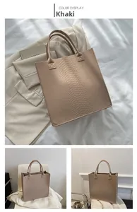 Detail showing khaki tote bag with premium snakeskin texture and reinforced top handles