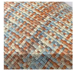 Close-up of multicolored woven texture with orange and blue yarns on a large tote bag
