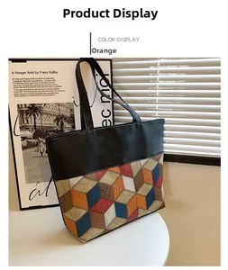 Detail of a large tote bag with orange geometric pattern and leather textures