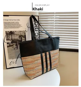 Close-up of khaki woven tote bag with black leather patchwork and texture detail