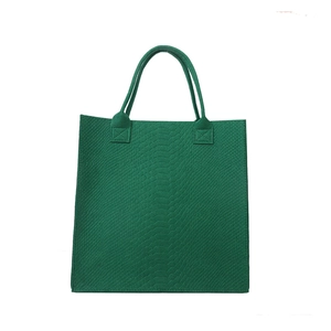 Minimalist green felt tote bag featuring stylish snakeskin pattern and reinforced handles