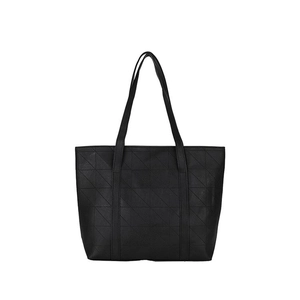 Detail of black tote bag with geometric triangle pattern and textured faux leather finish