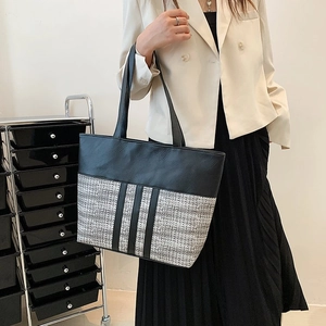 Large capacity tote bag in black leather and tweed patchwork with vertical stripe accents