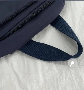 Detailed close-up of the durable blue nylon fabric and reinforced carrying handle