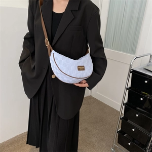 Fashionable checkered weave crescent crossbody bag with brown leather strap and trim