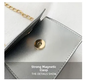 Detail shot of the strong magnetic closure on this silver-grey mini chain square bag