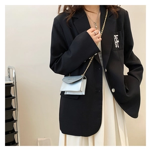 Chic silver-blue metallic mini chain crossbody bag styled with a black blazer and white skirt