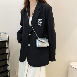 Chic silver mirror-finish mini flap chain crossbody bag paired with black blazer jacket