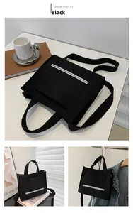 Detailed view of a black corduroy tote bag with adjustable shoulder strap and pocket