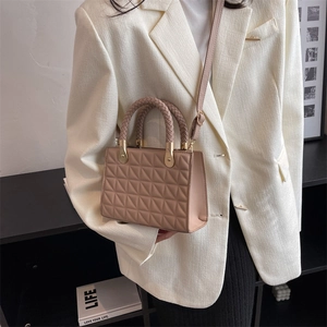 Nude pink quilted crossbody bag with woven handles and long shoulder strap for women
