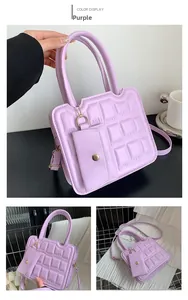 Detail of purple tote bag with chocolate-style embossed pattern and chain coin purse