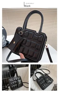 Detail of black quilted crossbody bag with matching mini pouch and top handle design
