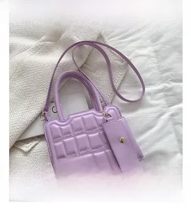 Detail of lavender quilted handbag with embossed pattern and detachable coin purse
