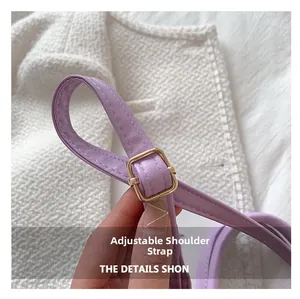 Detail of adjustable purple PU leather shoulder strap with gold metal buckle and stitching