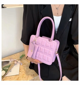 Lavender quilted handbag with matching mini pouch and adjustable crossbody strap detail