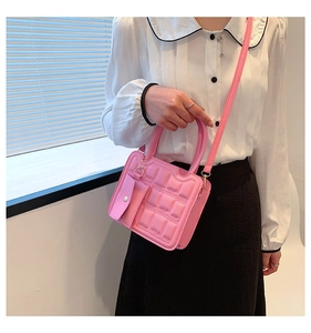 Pink waffle texture crossbody bag with mini pouch shown on a model in natural light