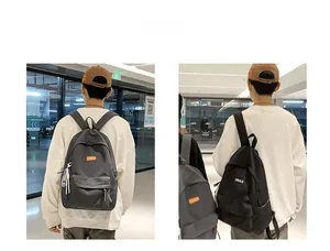 Detail view of neutral minimalist backpacks in black and grey durable nylon fabric
