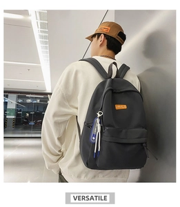 Close-up of a black waterproof backpack with MRMILID brand tag and blue strap detail