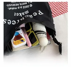 Top view of a black canvas tote bag showing large capacity for umbrella, tablet, and essentials