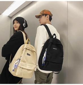 Detail view of MRMILID minimalist nylon backpacks in beige and black for men and women