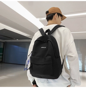 Detail view of durable black backpack with white MRMILID lettering and stylish blue rope charm