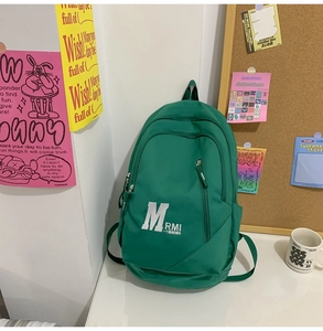 Detailed close-up of grass green campus backpack with a vertical front zipper pocket