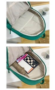 Detail view of green backpack interior showing spacious main compartment and laptop pocket