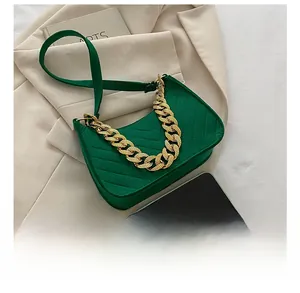 Quilted green hobo bag detail with gold chain strap and smartphone size comparison