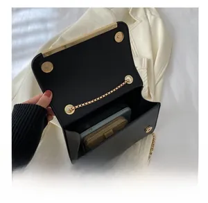 Interior view showing capacity for a smartphone and wallet in black leather crossbody bag