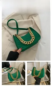 Detailed view of green felt baguette bag with chevron quilting and golden chain strap