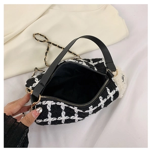 Top view of tweed plaid handbag interior with metal chain and plush lamb charm