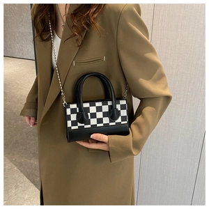 Classic black and white checkered crossbody bag with silver chain strap and handle