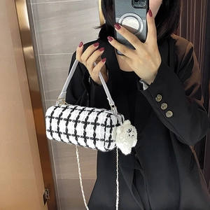 Fashionable black and white tweed barrel bag with white leather handle and cute bear charm