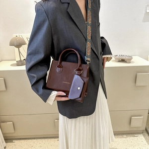 Retro brown leather square handbag with an ethnic-style wide strap and mini pouch