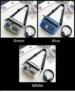 Three casual canvas crossbody bags in green, blue, and white with front mesh pocket