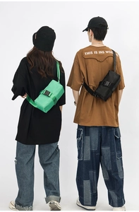 Detail view of neon green and black oxford crossbody bags with buckle closure and wide strap