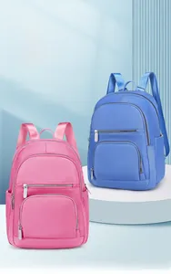 Detail view of pink and blue stylish backpacks with multiple zip pockets for storage
