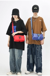 Detail shot of Oxford cloth crossbody bag with durable black buckle in red and blue