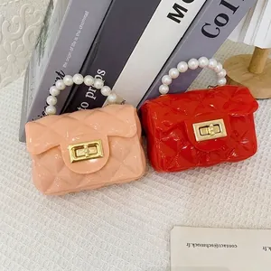 Mini quilted jelly handbags with pearl handles in pink and red colors for women